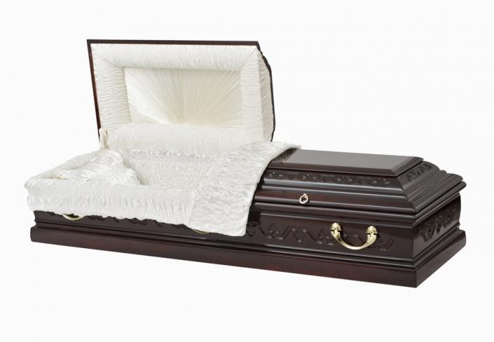 An exquisitely crafted casket displaying the warmth and beauty of dark wood.  Golden handles adorn this beautiful piece.