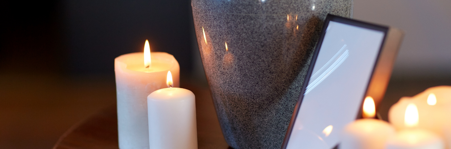 candles burning near a cremation urn