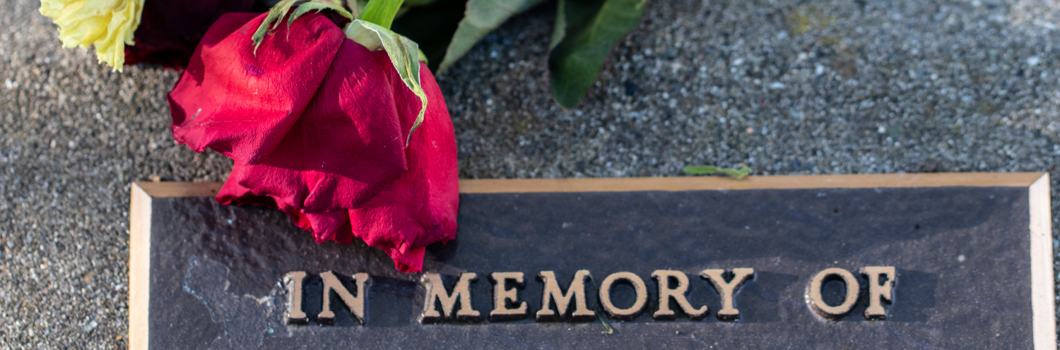 flower draped over funeral plaque